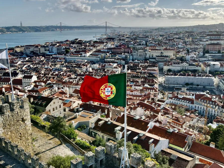 Castelo de São Jorge viewpoint with the Portuguese flag over Lisbon